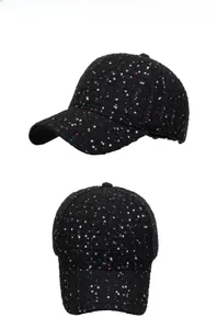Detailed close-up showing black tweed baseball cap with colorful sequins and shiny texture
