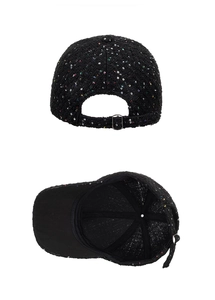 Detail of tweed baseball cap back with adjustable metal buckle and sequin texture