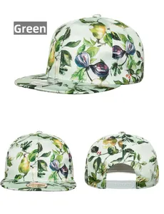 Detail view of mint green snapback cap with tropical fig leaf and fruit digital print
