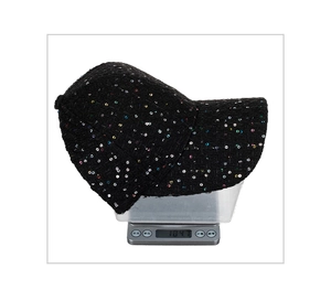 Detail view of a black tweed baseball cap with colorful sequins weighing 104.1g on a scale