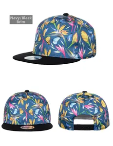 Detailed views of navy snapback hat with tropical flower patterns and adjustable black strap