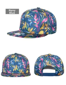 Close-up of navy blue snapback cap featuring tropical bird of paradise and floral prints