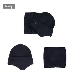 Detailed knit texture and metallic logo on navy blue thermal winter hat and scarf set