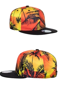 Detail of snapback hat showing vibrant tropical coconut tree digital print in warm sunset tones