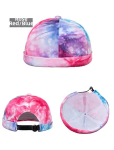 Detail view of tie-dye skullcap showing rose red and blue fabric with adjustable strap