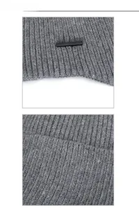 Close-up of grey knit beanie fabric texture and XHBOY black metallic brand emblem