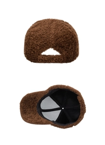 Close-up of the brown faux shearling baseball cap showing back closure and black lining