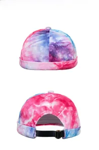 Macro view of tie-dye skullcap showing starry pink and blue texture and adjustable buckle