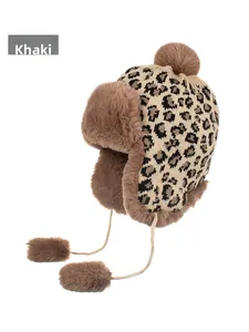 Detail of winter leopard knit hat with khaki faux fur lining and plush earflaps