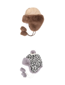 Detail view of khaki and leopard faux fur trapper hats with pom-pom ties for winter
