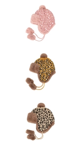 Close-up of leopard print knit trapper hats with faux fur lining and pom-pom details