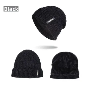Detail of black knit beanie featuring warm fleece lining and fashion leather patch