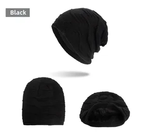 Detail view of black knit beanie showing thermal fleece lining and ribbed wave texture