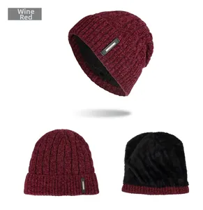 Detail of wine red cable knit beanie featuring warm black fleece lining and fashion tag