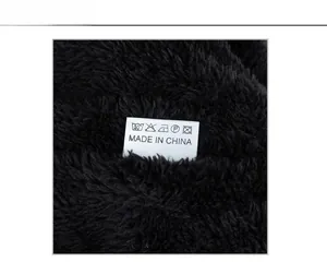Detail of soft faux fur lining with care label inside the vertical striped knit beanie