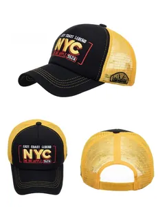 Detail view of NYC 3D embroidery and breathable mesh on a black and yellow trucker hat