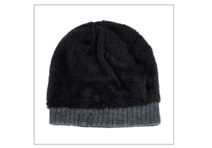 Detail of winter knit beanie with black faux fur top and gray ribbed texture cuff