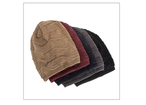 Close-up of knit beanies in four colors showing unique wave texture and soft fabric