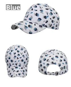 Detail view of graffiti pattern baseball cap with adjustable metal buckle and blue ink splashes