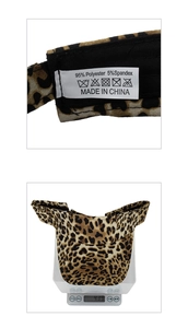 Close-up of leopard print visor wash label showing 95% polyester and weight of 43.9g