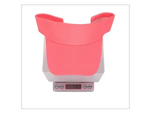 Close-up of lightweight pink knitted sun visor hat weighing 58.3g on a scale