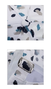Close-up of baseball cap featuring splash ink graffiti print and metal adjustment buckle