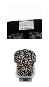 Close-up of leopard print baseball cap material label and 61.5g product weight scale