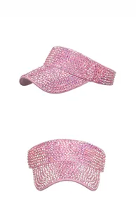 Detailed close-up of pink sun visor hat with sparkling rhinestones for outdoor leisure