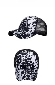 Detail of cow print trucker hat with black mesh back and adjustable snapback closure