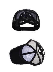 Detail of high ponytail mesh trucker hat with elastic criss cross bands and cow print brim