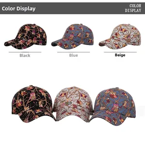 Detailed view of colorful owl pattern prints on black, blue, and beige baseball caps
