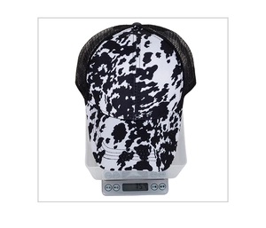 Detailed view of striped trucker hat on an electronic scale showing weight of 75.4g
