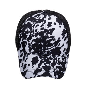 Adult cow print trucker hat with black mesh back and black white animal spotted pattern