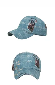Detailed view of vintage light blue washed denim baseball cap with retro lettering prints