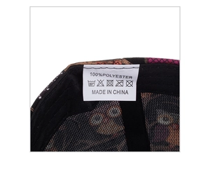 Detail view showing 100% polyester material label and stitching on printed owl baseball cap