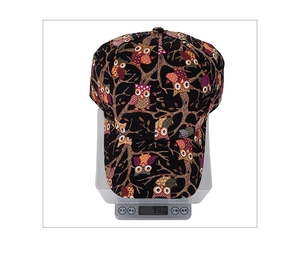 Detailed close-up of a printed owl baseball cap on an electronic scale weighing 90g