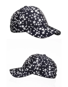 Detailed view of black baseball cap featuring all-over silver star patterns and structured crown