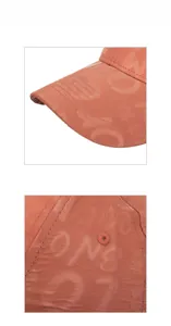 Detail of orange faux leather baseball cap showing embossed patterns and fine stitching