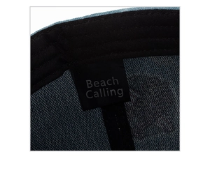 Close-up of Beach Calling label on breathable blue mesh lining of this baseball cap
