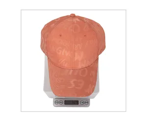Detailed close-up of a coral satin baseball cap weighing 72.4 grams on a digital scale