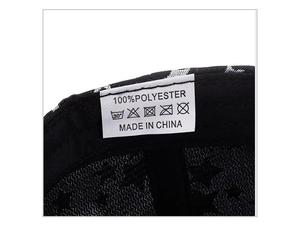 Detail of baseball cap interior showing 100% polyester wash label and silver star print