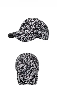 Close-up of black baseball cap featuring white skull print and curved brim detail