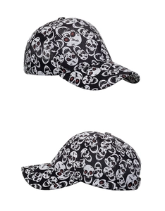 Dual view of black baseball cap featuring white skull print and red eye accents