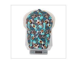 Detailed view of lightweight blue sunflower baseball cap weighing 71.3g on a scale