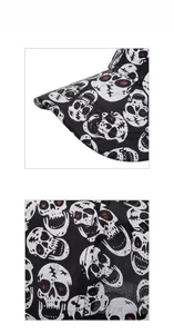 Close-up detail of black baseball cap with white skull patterns and red glitter accents