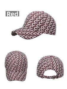 Detail view of red baseball cap with monogram print showing front side and back metal buckle