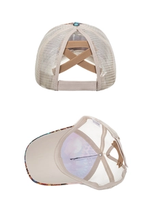 Detail of beige mesh trucker hat featuring elastic criss-cross ponytail hole and floral brim