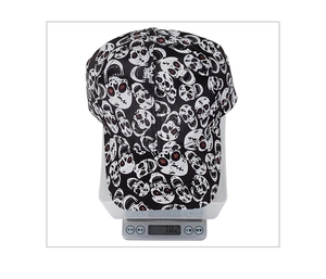 Detailed top view of black baseball cap with white skull patterns on a digital scale weighing 78g