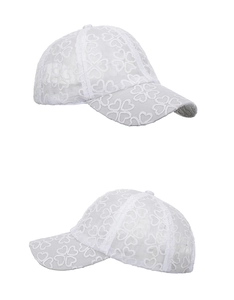 Detailed close-up of white floral lace embroidery on breathable mesh baseball cap