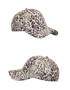 Detailed macro view of the gold leopard print texture on a stylish baseball cap